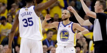 Golden State Warriors forward Kevin Durant (35) celebrates with guard Stephen Curry (30) during the second half of Game 1 of basketball's NBA Finals against the Cleveland Cavaliers in Oakland, Calif., Thursday, May 31, 2018. (AP Photo/Marcio Jose Sanchez)