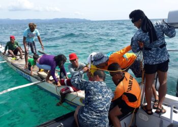 Philippine Coast Guard personnel rescue passengers of a stalled banca off Caluya, Antique. Photo courtesy of Philippine coast guard.