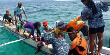 Philippine Coast Guard personnel rescue passengers of a stalled banca off Caluya, Antique. Photo courtesy of Philippine coast guard.