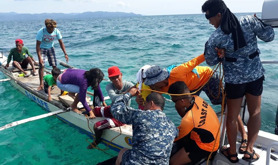 Philippine Coast Guard personnel rescue passengers of a stalled banca off Caluya, Antique. Photo courtesy of Philippine coast guard.